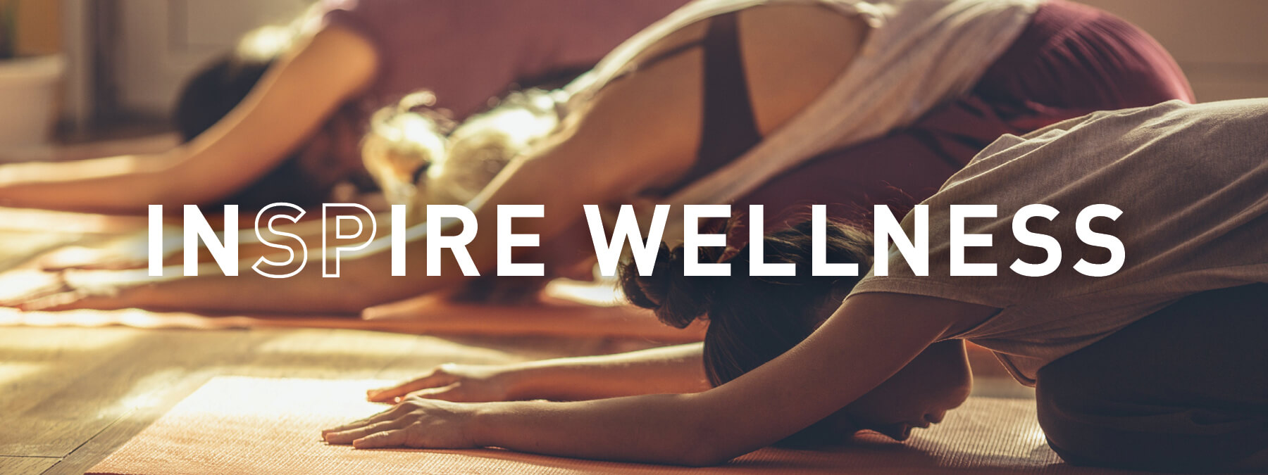 welness INSPIRE wellness - group doing yoga